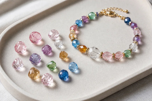 Mixed crystal beads beside a custom bracelet design
